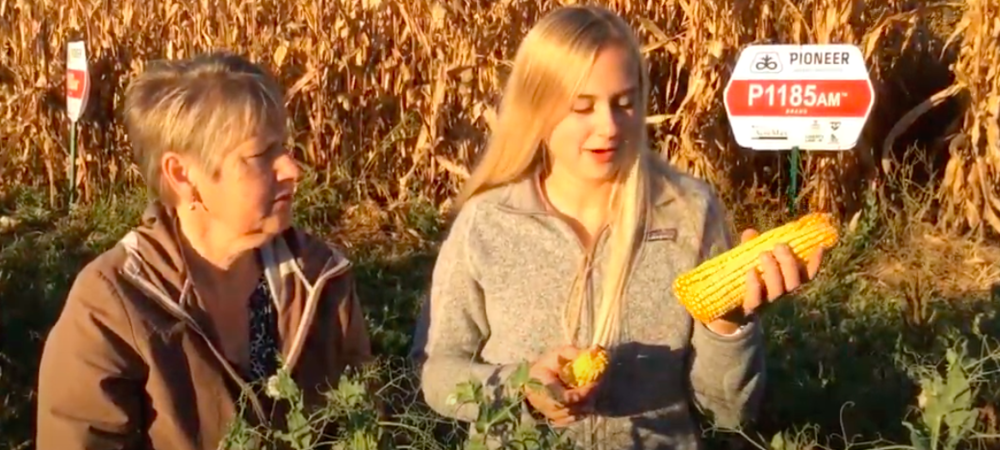 Mrs. Meggers & student in a corn field