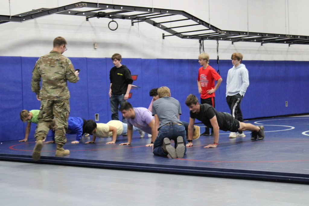 Military recruiter visiting with students