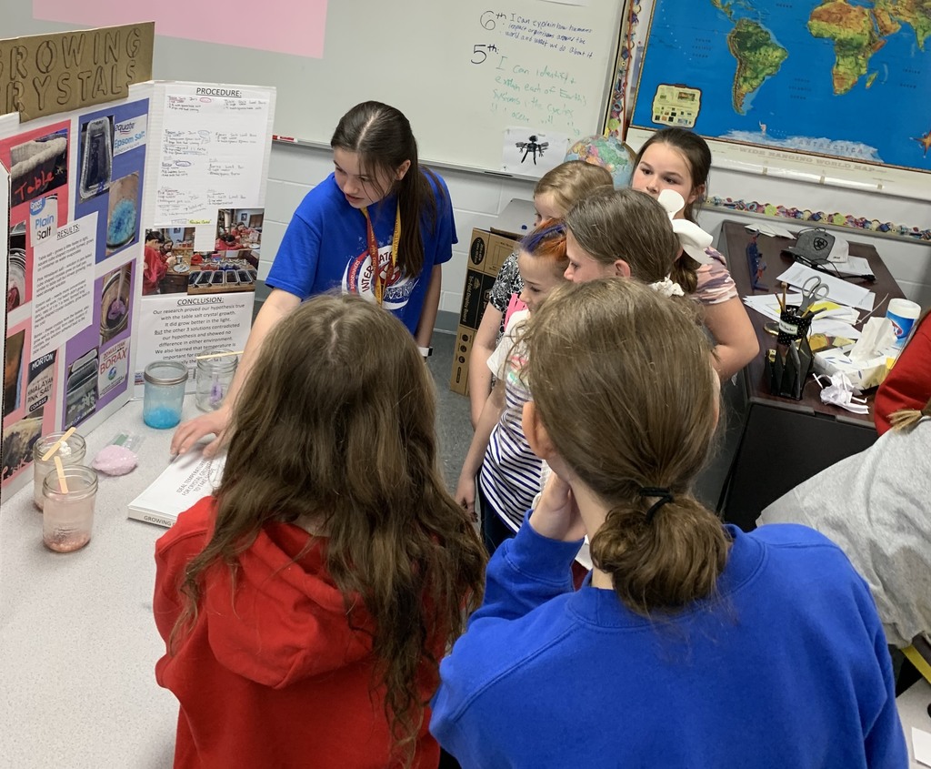 Students sharing science fair projects with classmates