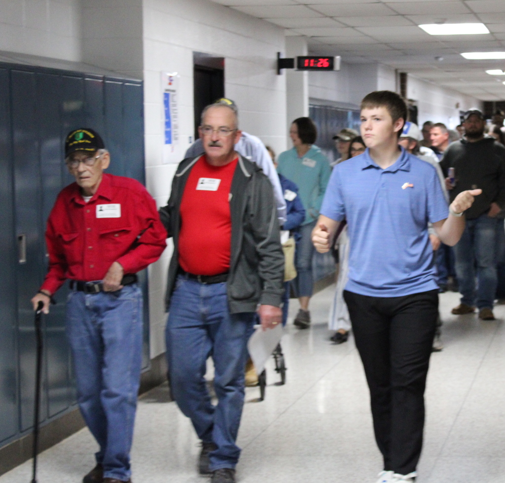 Student walking veterans down the halls